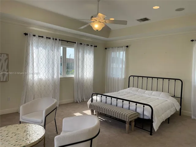 a bedroom with a bed mirror and window