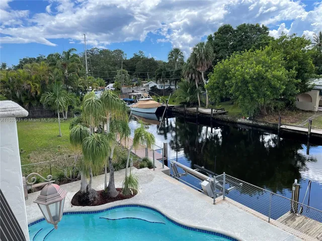 a view of a swimming pool and outdoor seating
