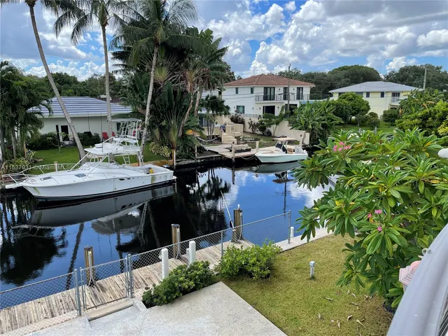 a view of a house with backyard sitting area and garden