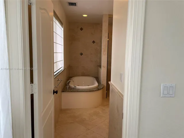 a bathroom with a granite countertop toilet and a sink
