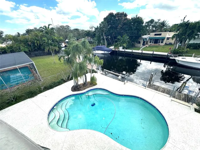 a view of a swimming pool with a yard
