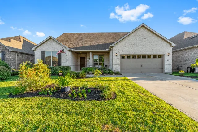 a front view of house with yard and trees around