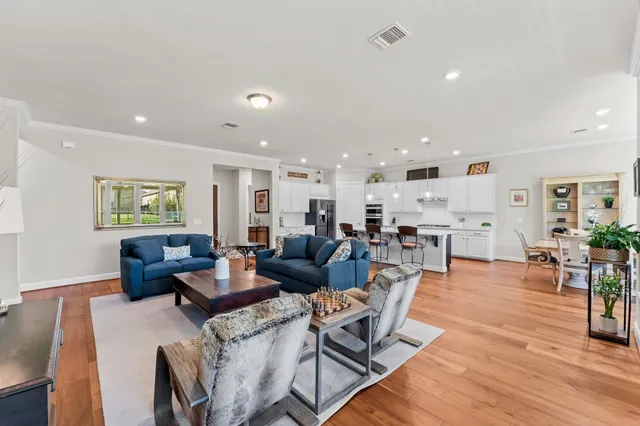 a living room with furniture and wooden floor