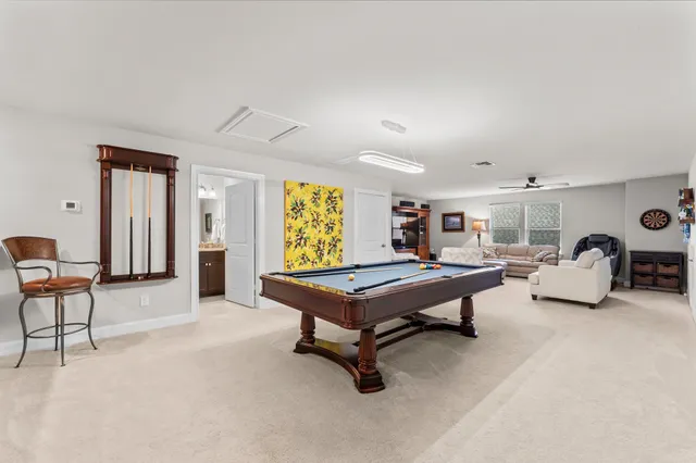 a living room with furniture a rug and a window