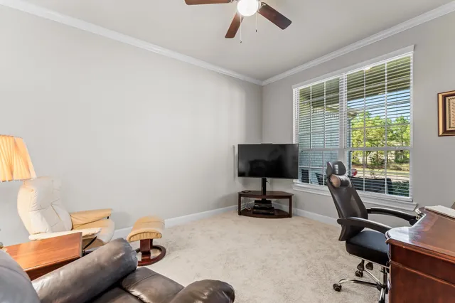a view of a workspace with furniture and a window