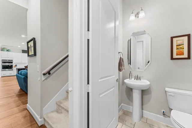 a bathroom with a sink toilet and a mirror