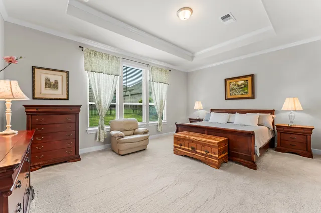 a spacious bedroom with a bed and a couch