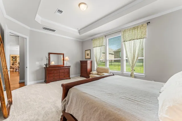 a bedroom with a large bed and a tv