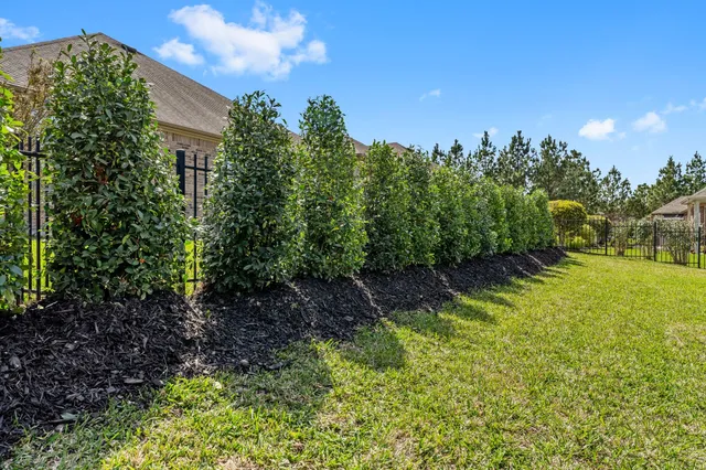 a view of a garden with a building in the background