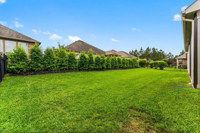 an empty room with wooden floor and large window