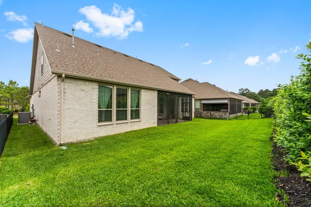 a view of a house with a yard and potted plants