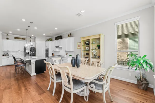 a view of a dining room with furniture and wooden floor