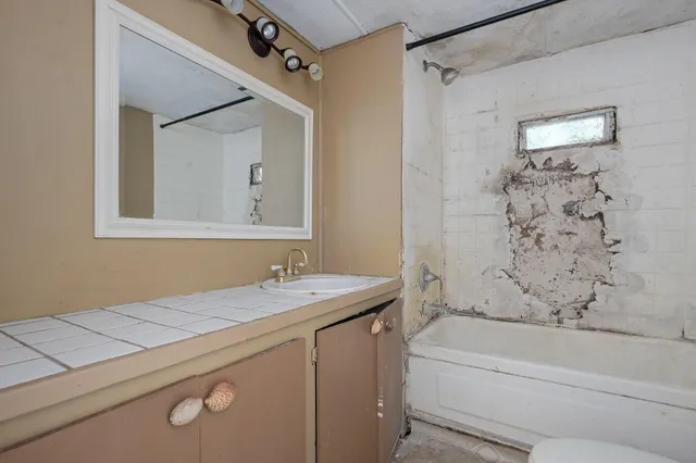 a view of a house with swimming pool and sitting area