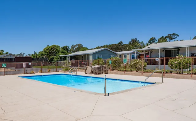 a view of a swimming pool with outdoor seating