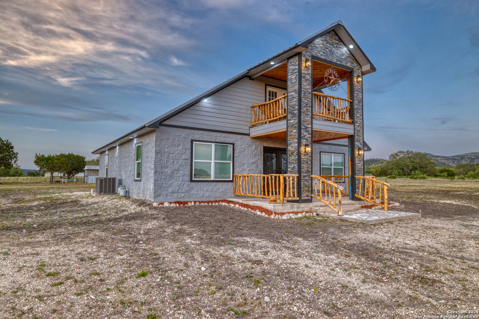 136 Cardinal Drive Camp Wood, TX 78833 - Photo 2 of 62 a view of a house with backyard and trees