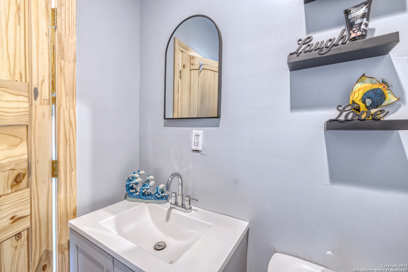 136 Cardinal Drive Camp Wood, TX 78833 - Photo 28 of 62 a bathroom with a sink mirror and vanity