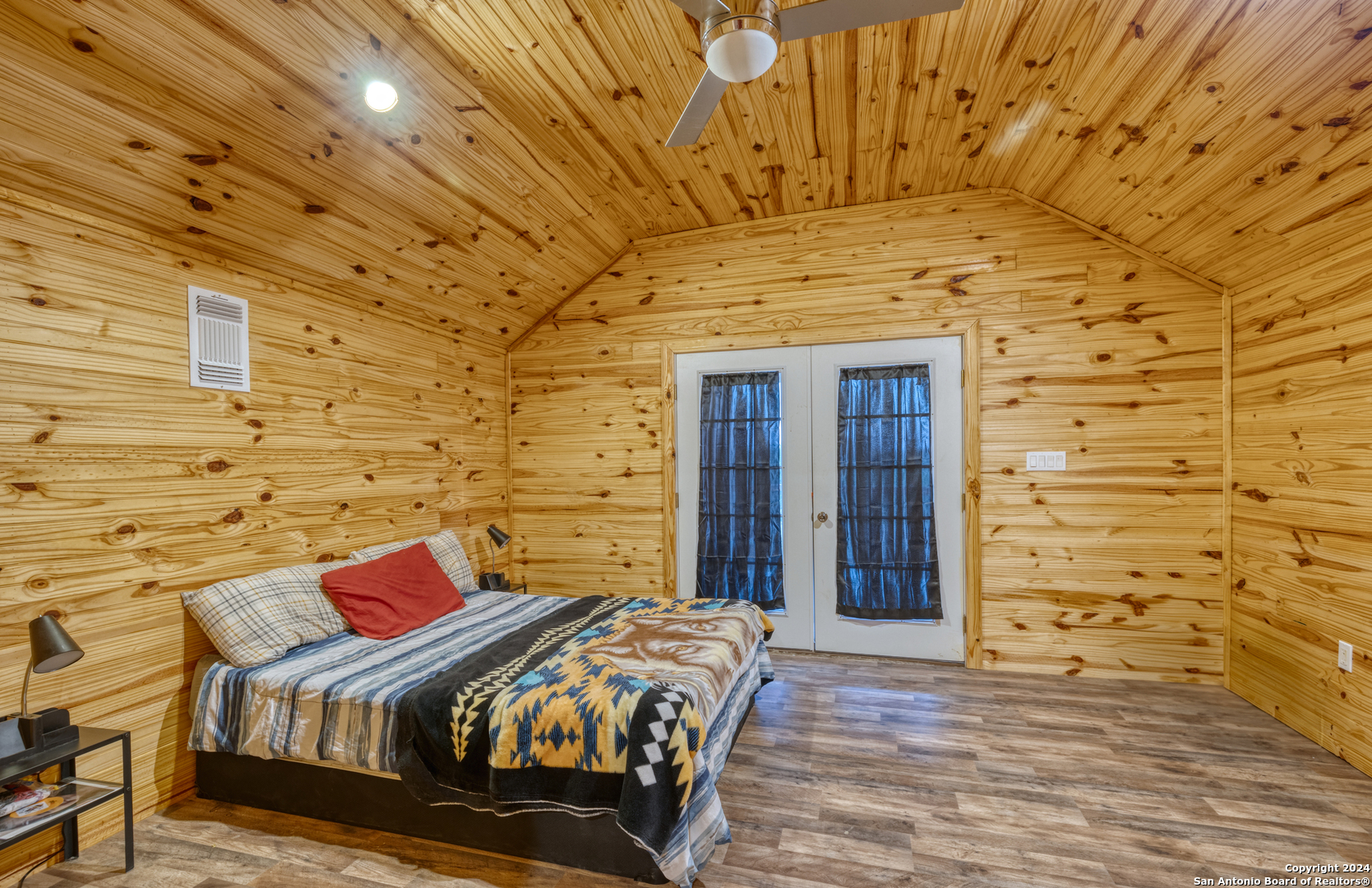 136 Cardinal Drive Camp Wood, TX 78833 - Photo 33 of 62 a bedroom with a bed and a wooden floor