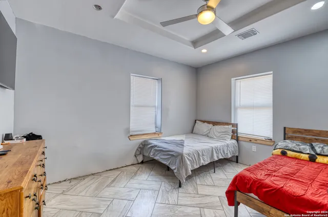 a view of a lounge chairs in the back yard of the house
