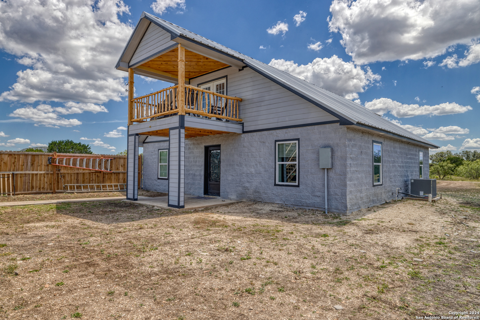 136 Cardinal Drive Camp Wood, TX 78833 - Photo 50 of 62 a front view of a house with a yard and garage