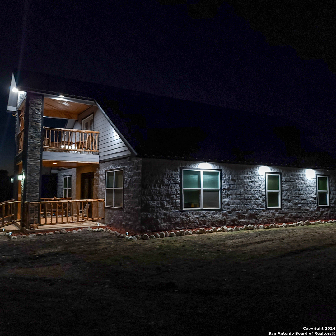 136 Cardinal Drive Camp Wood, TX 78833 - Photo 59 of 62 a front view of a house with a garden
