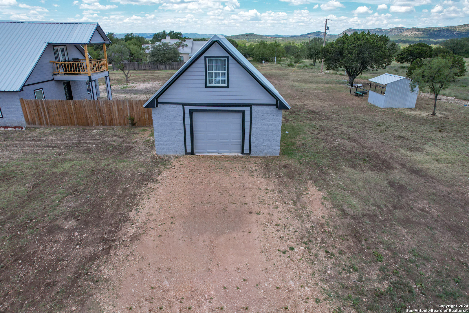 136 Cardinal Drive Camp Wood, TX 78833 - Photo 9 of 62 a view of a barn in a yard