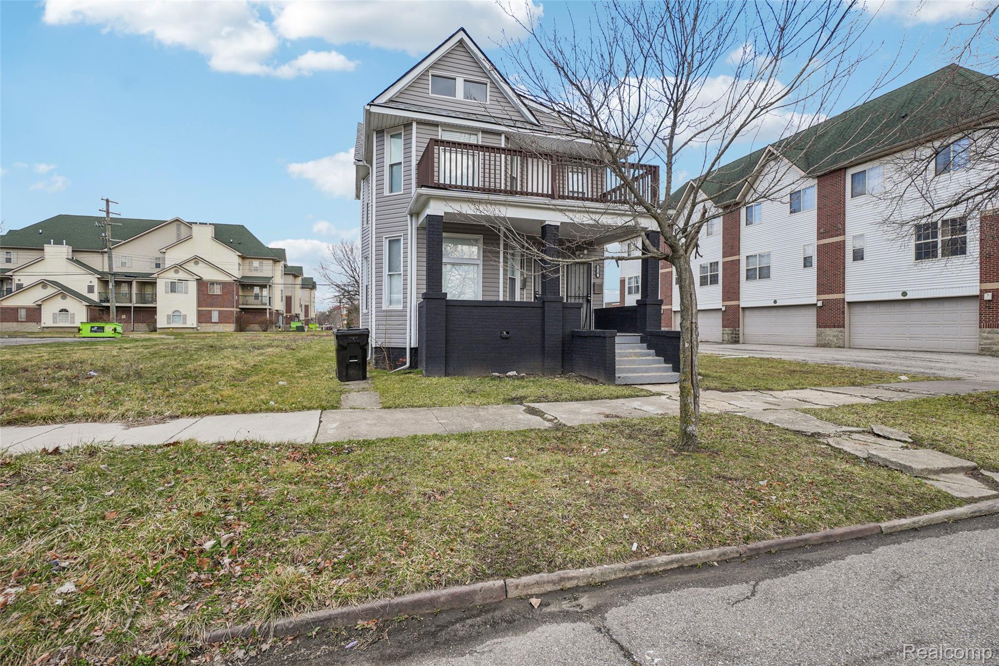 3822 Wabash Street Detroit, MI 48208 - Photo 3 of 17 View of front facade featuring a front yard, a residential view, a porch, and an attached garage