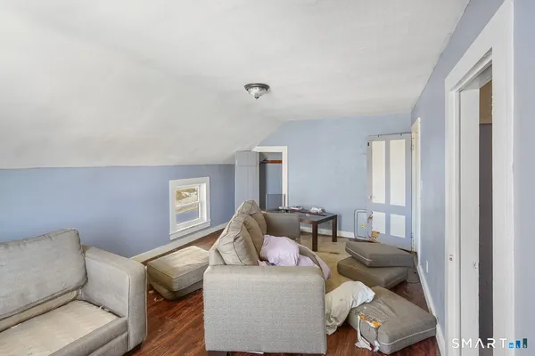 a view of room with window and wooden floor