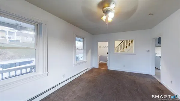 a view of staircase with wooden floor and white walls