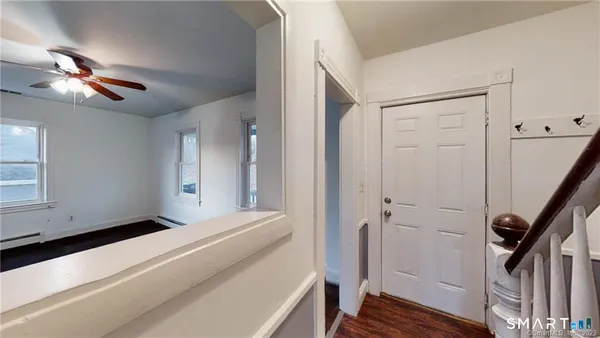 a view of a livingroom with a ceiling fan and window