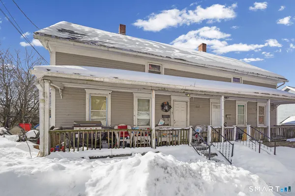 a view of a house with chairs in the patio