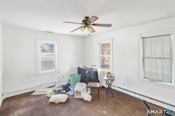 a view of entryway and gallery with wooden floor