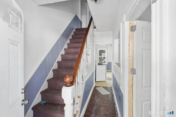 a hallway with a view of living room