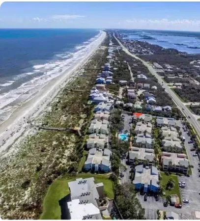 a view of a dry yard with wooden fence