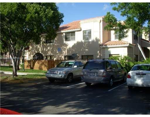 513 Racquet Club Road, Unit 55 Weston, FL 33326 - Photo 3 of 25 a front view of a house with a garden