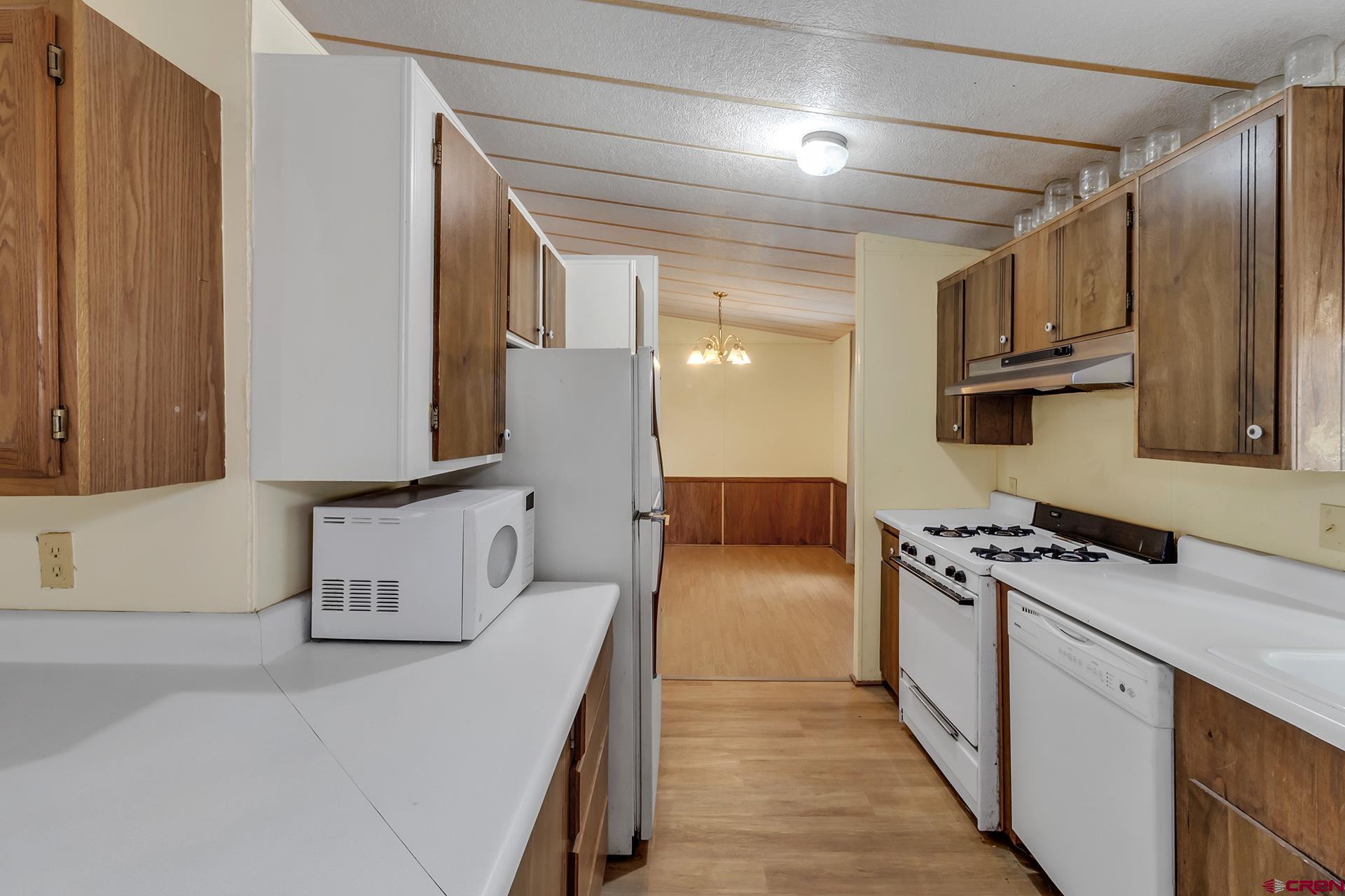 400 Riley Lane Delta, CO 81416 - Photo 12 of 35 a kitchen with a stove a sink and a refrigerator