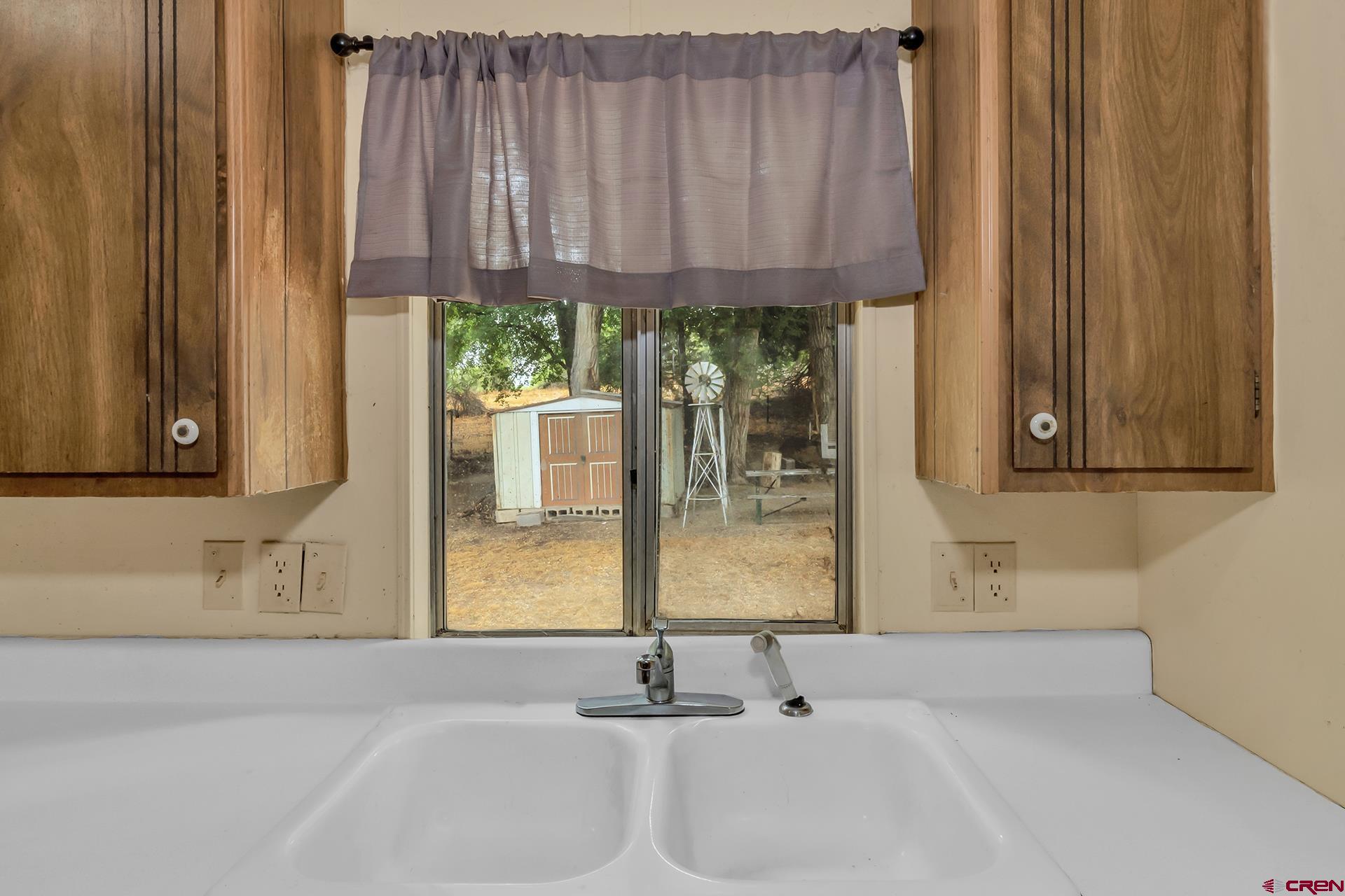 400 Riley Lane Delta, CO 81416 - Photo 13 of 35 a bathroom with a sink and a mirror