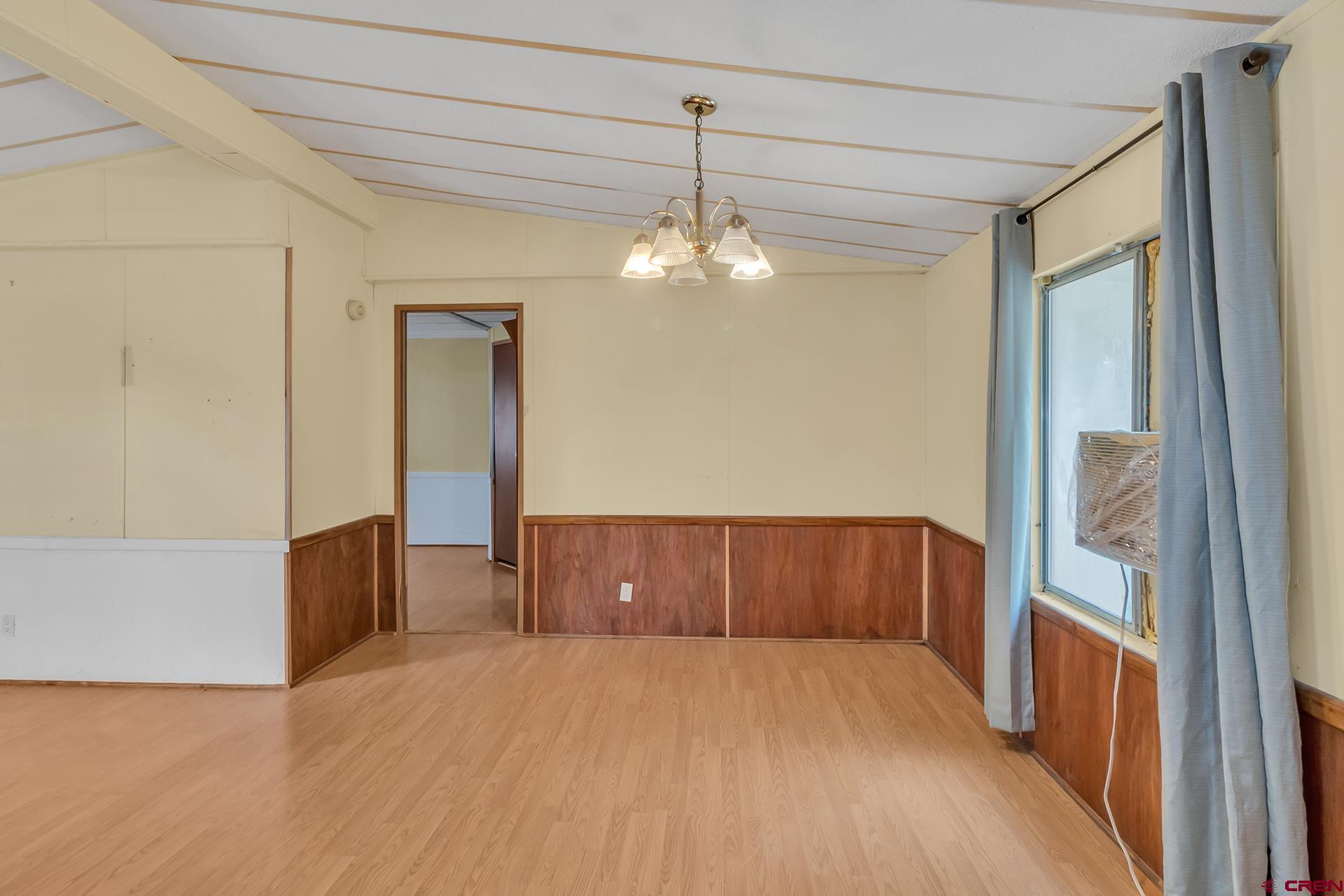 400 Riley Lane Delta, CO 81416 - Photo 14 of 35 a view of a room with wooden floor and chandelier