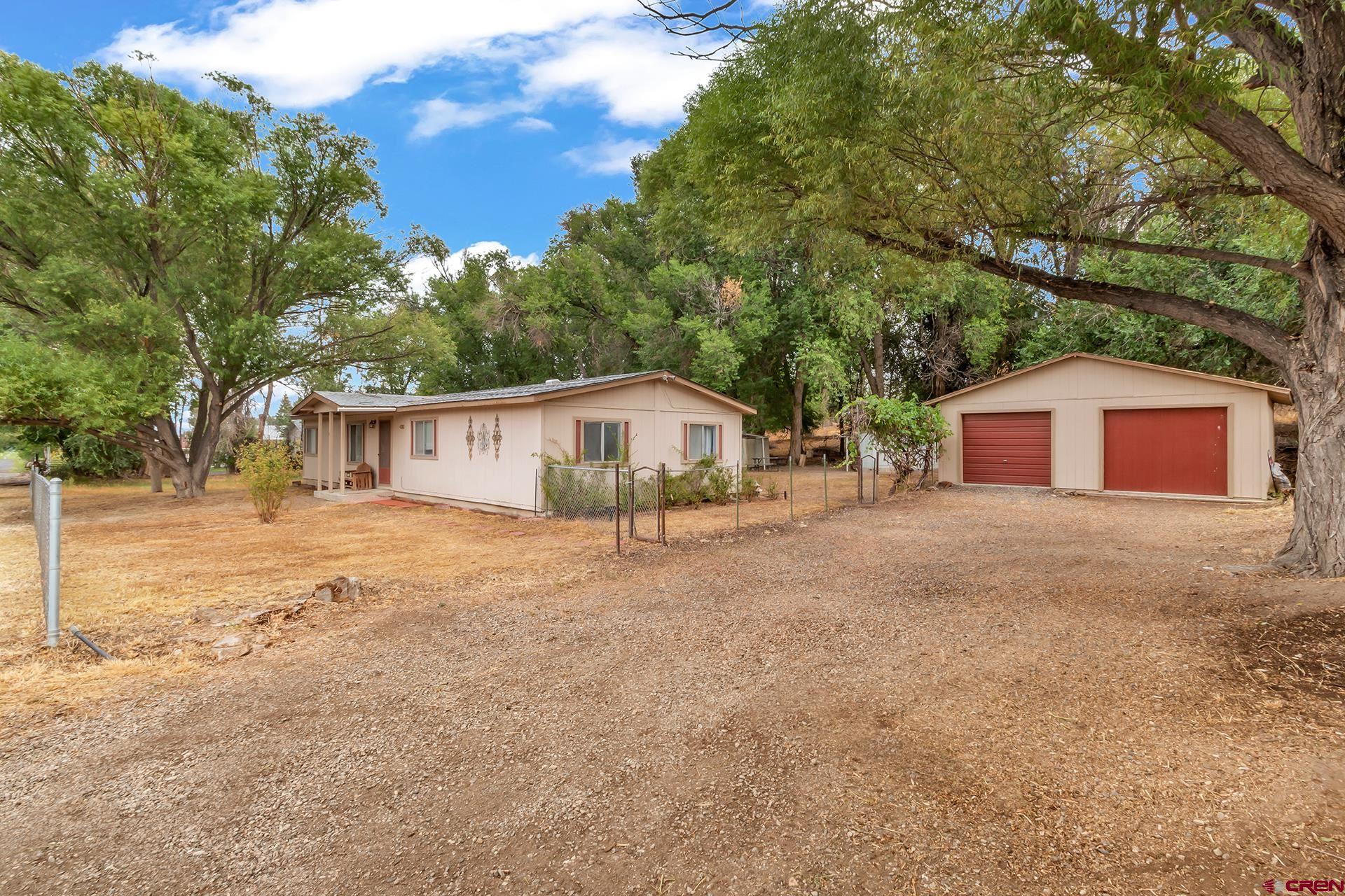 400 Riley Lane Delta, CO 81416 - Photo 2 of 35 a house with trees in front of it