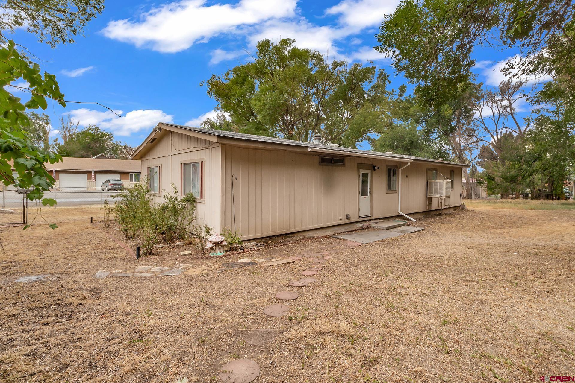 400 Riley Lane Delta, CO 81416 - Photo 29 of 35 a view of a house with a yard