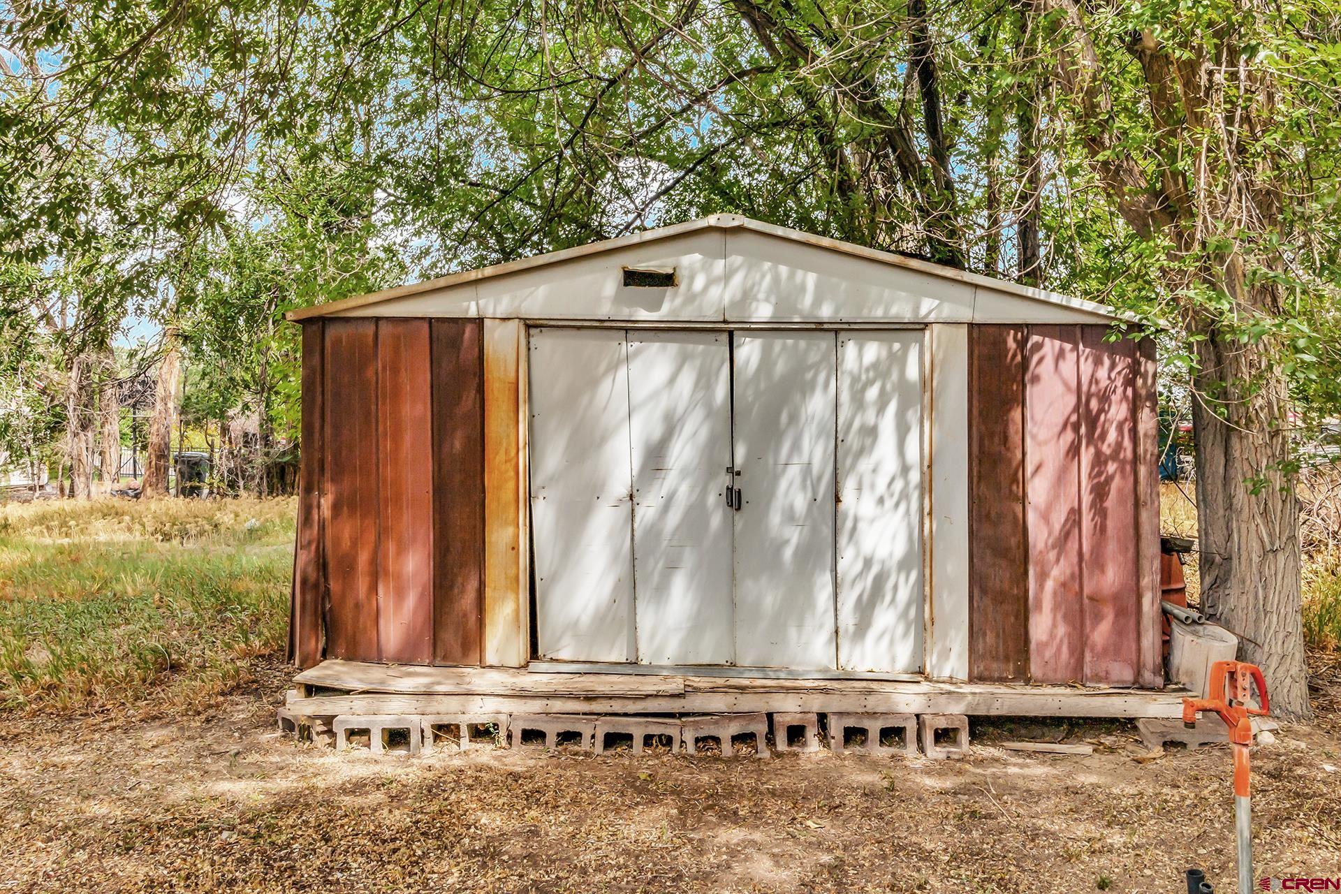 400 Riley Lane Delta, CO 81416 - Photo 34 of 35 a black car parked in front of a yard