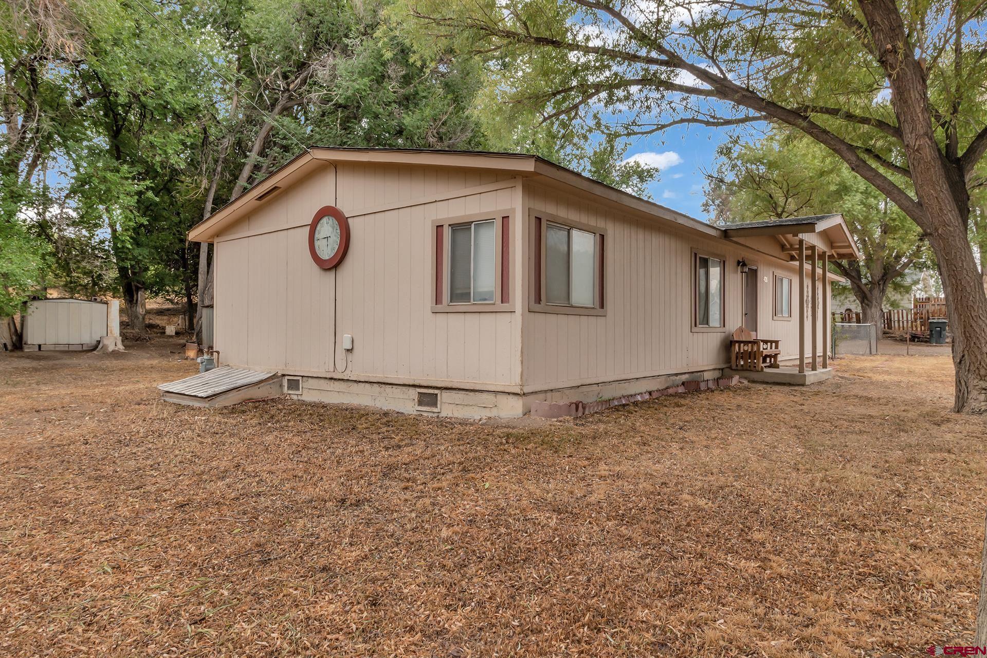 400 Riley Lane Delta, CO 81416 - Photo 4 of 35 a house with trees in the background
