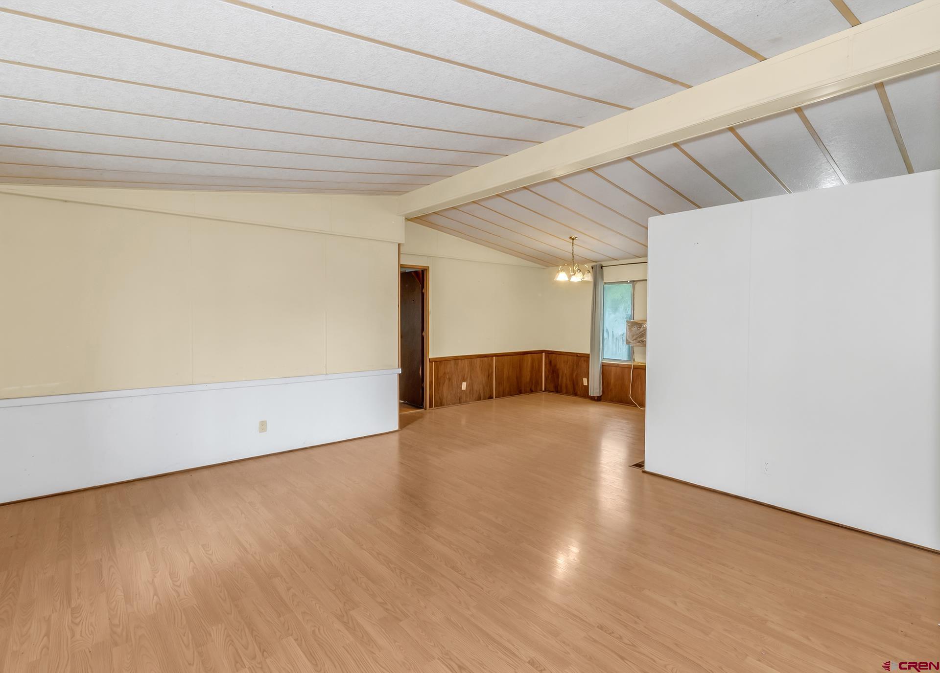 400 Riley Lane Delta, CO 81416 - Photo 7 of 35 a view of an empty room with wooden floor