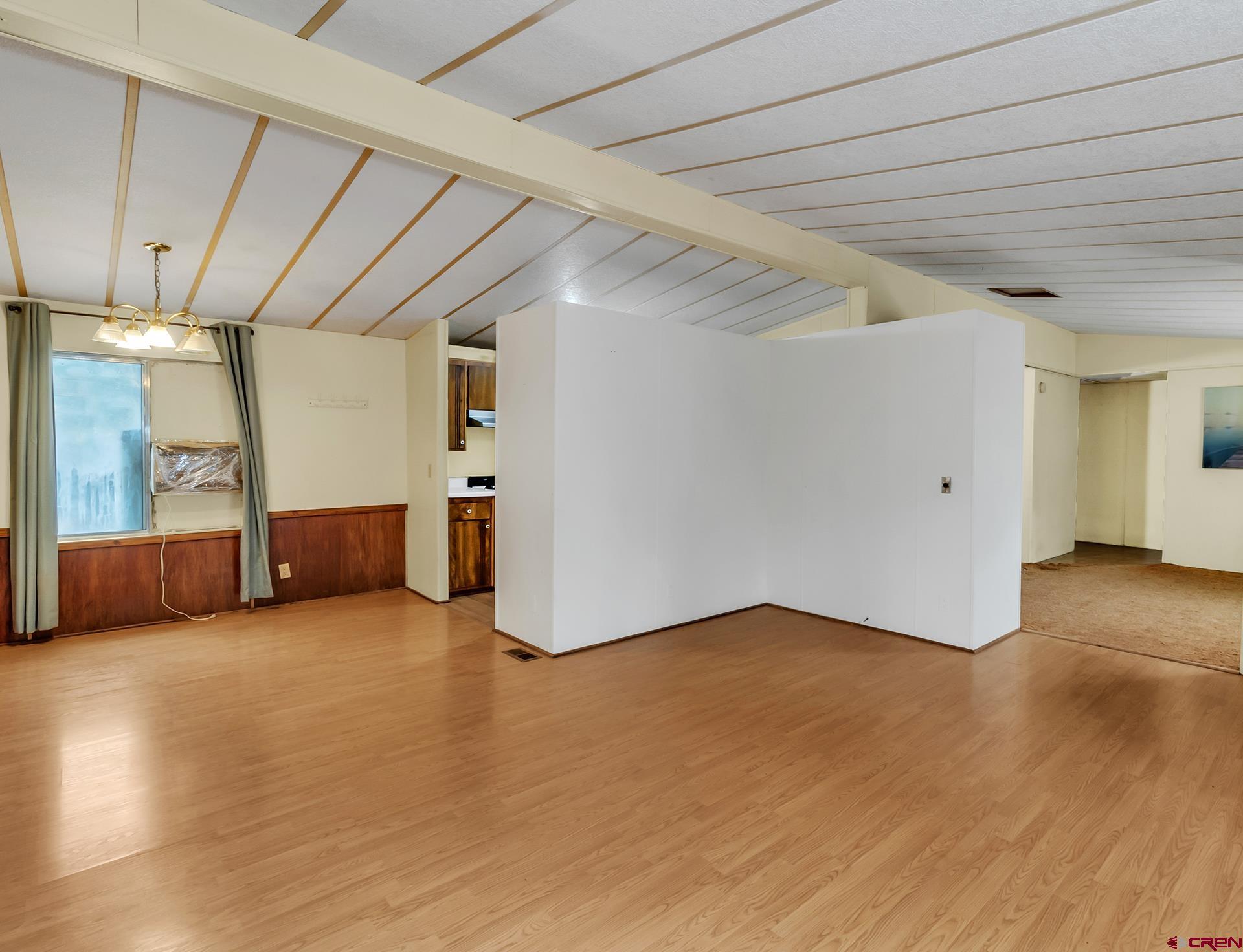 400 Riley Lane Delta, CO 81416 - Photo 8 of 35 a view of an empty room with wooden floor