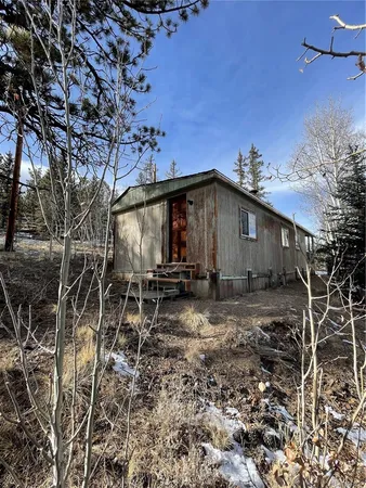 a view of a house with yard and sitting area