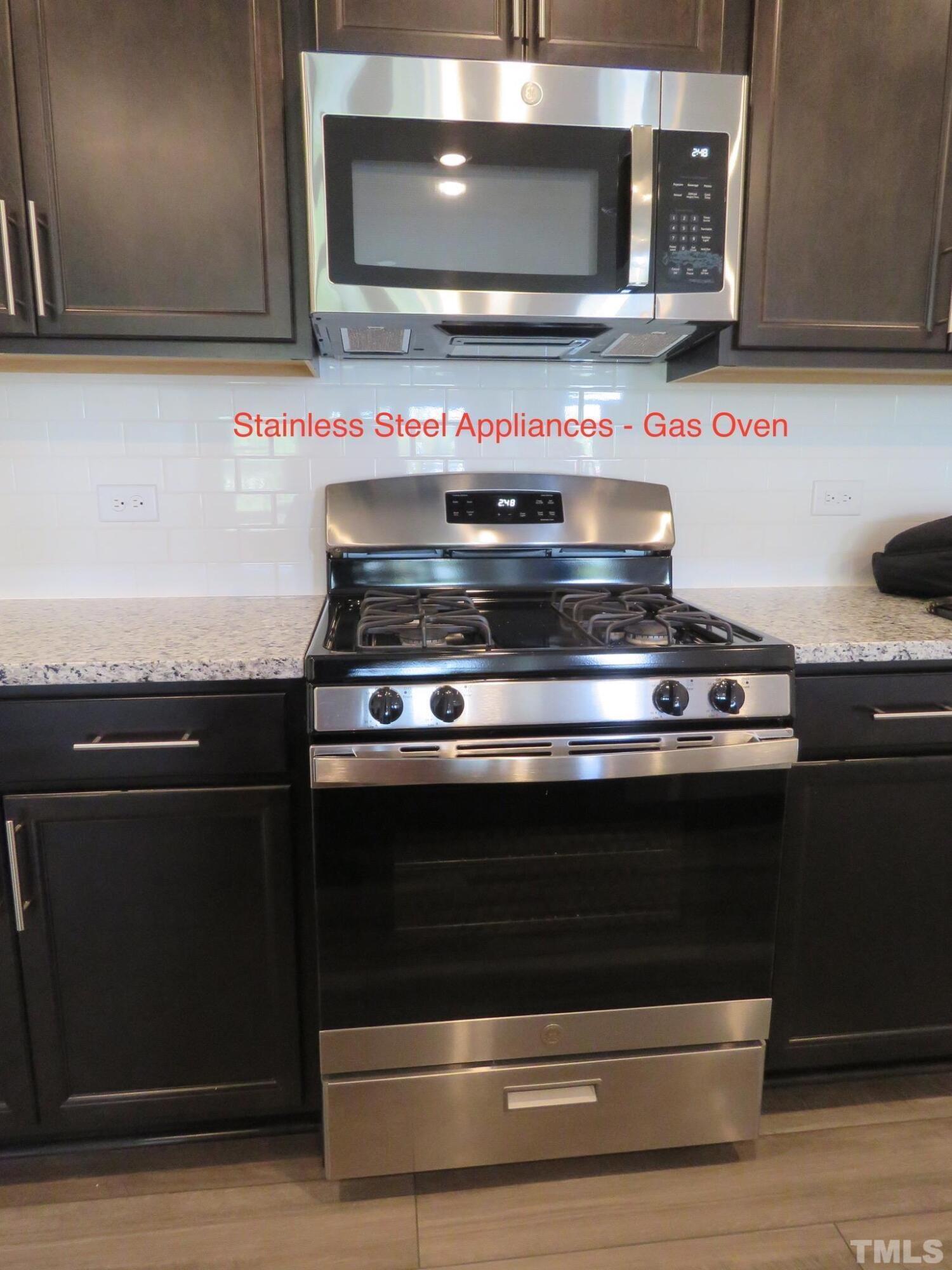 5118 Anamosa Street Raleigh, NC 27610 - Photo 18 of 36 a stove top oven sitting inside of a kitchen