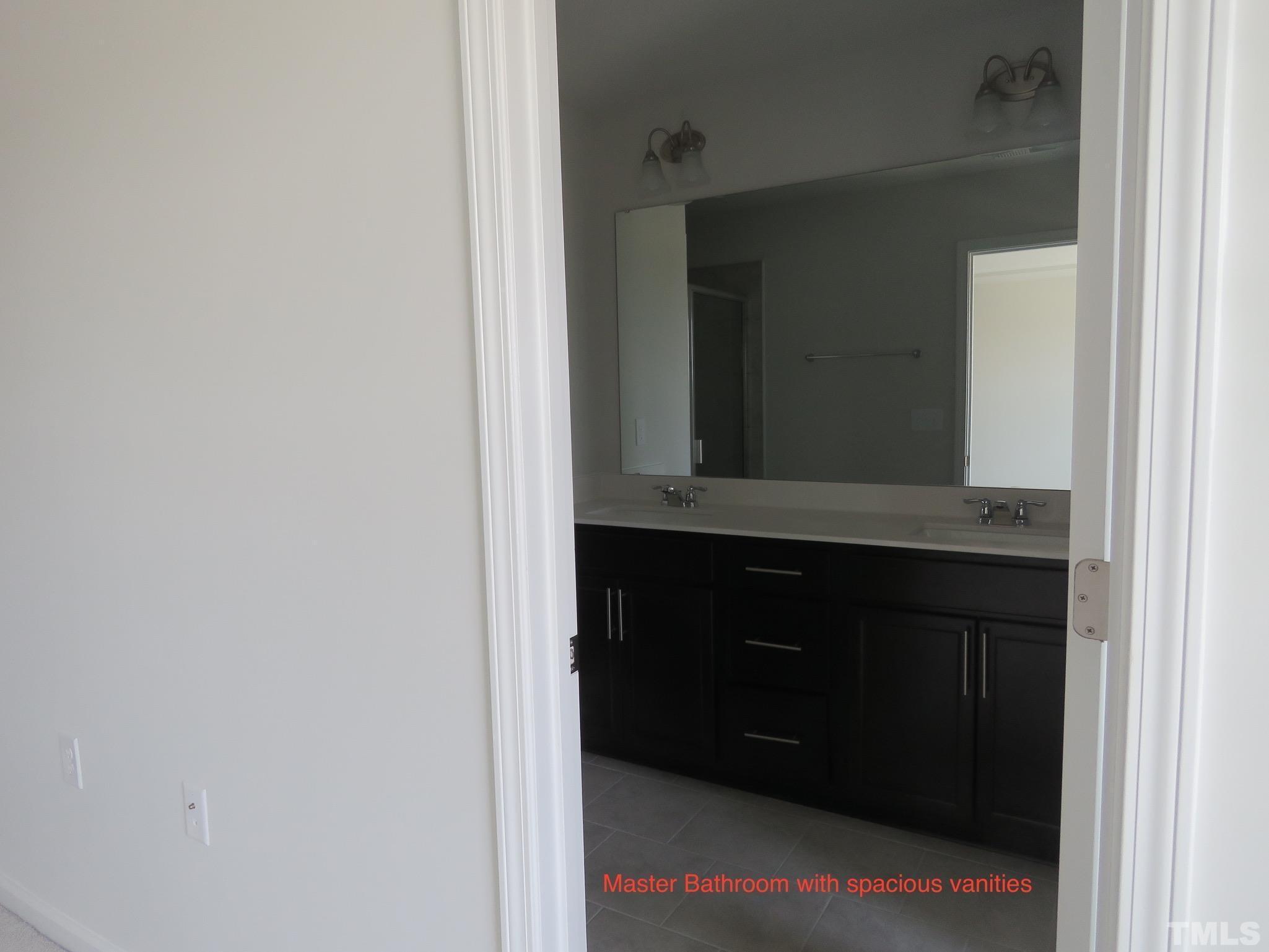 5118 Anamosa Street Raleigh, NC 27610 - Photo 29 of 36 a bathroom with a sink and a mirror