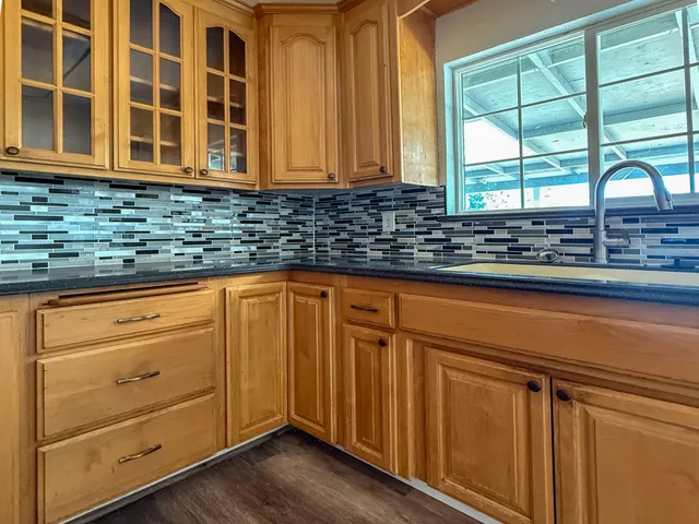 a kitchen with stainless steel appliances granite countertop cabinets and window