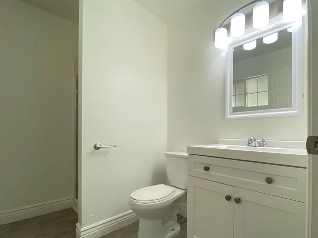 a bathroom with a toilet a sink and mirror