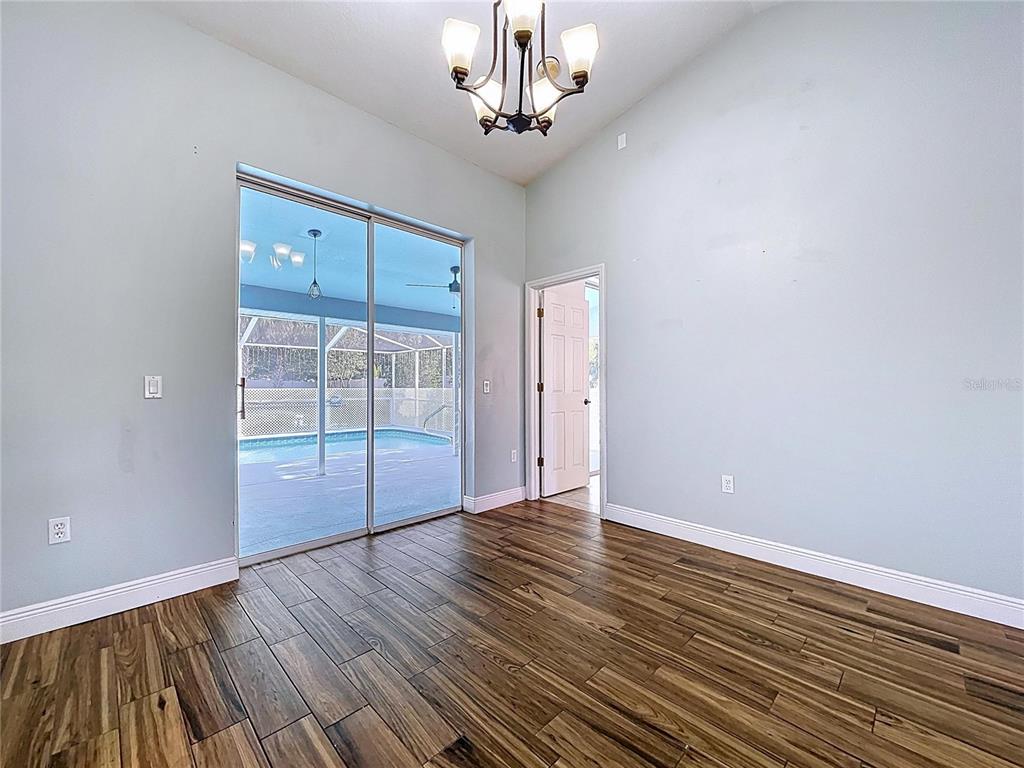 18812 Bascomb Lane Hudson, FL 34667 - Photo 19 of 57 wooden floor in an empty room with a window
