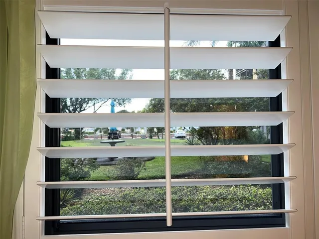 a bathroom with a granite countertop toilet sink and mirror